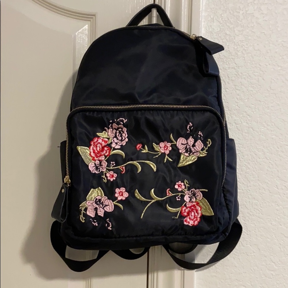 black backpack with floral details